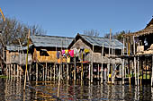 Inle Lake Myanmar. All the buildings are constructed on piles. Residents travel around by canoe, but there are also bamboo walkways and bridges over the canals, monasteries and stupas. 